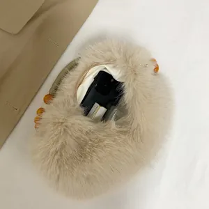 Plush beige faux fur tote bag with beaded handle and spacious interior for daily essentials