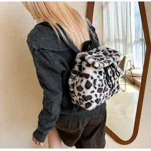 Detail of faux rabbit fur leopard print backpack with drawstring and flap closure