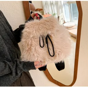 Detail of soft beige faux fur backpack showing fluffy texture and black drawstring closure