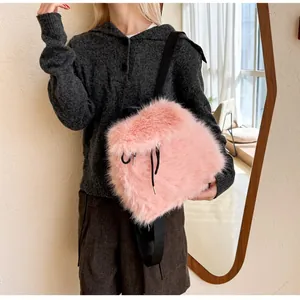 Close-up of pink faux rabbit fur backpack with black drawstring and nylon straps