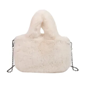 Plush faux fur crossbody bag in beige with soft texture and slim black chain strap