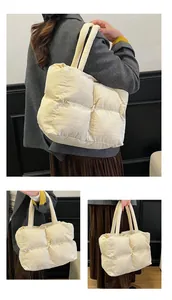 Detailed view of quilted puffer tote bag in cream white showing soft padded texture