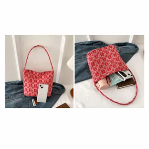 Macro view of red bridal tote bag with Xi character showing spacious interior and items