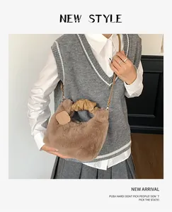 Detail of plush faux fur handbag with leather handle and metal chain for winter fashion