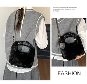 Detail of black faux fur plush handbag with pleated leather handle and brand tag