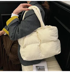 Chic quilted puffer tote bag in cream white styled with a gray suit and brown skirt