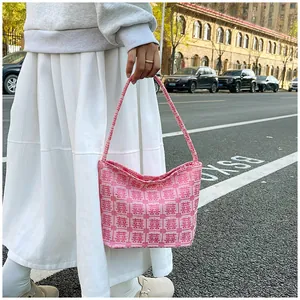 Detail of pink tote bag with traditional double happiness pattern in urban street setting