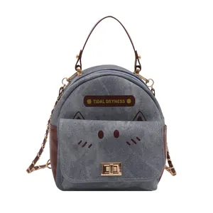 Mini denim backpack for women featuring cute cat face design and brown leather trim
