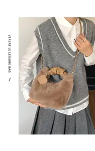 Detailed close-up of fluffy brown plush crossbody bag with leather strap and top handle