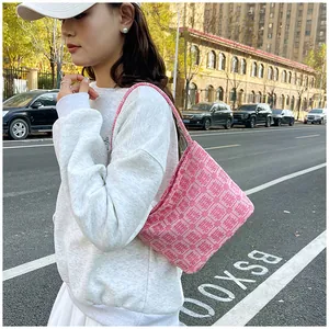 Detailed view of pink tote bag with Chinese Xi character jacquard and textured fabric