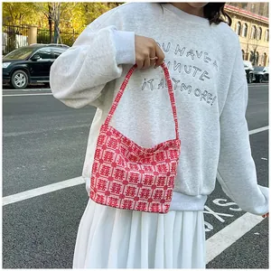 Close-up of red woven tote bag featuring traditional Chinese double happiness patterns