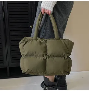 Detail of army green quilted tote bag featuring padded nylon material and puffer texture