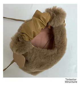 Detail showing internal structure of brown faux fur bag with pink lining and zipper