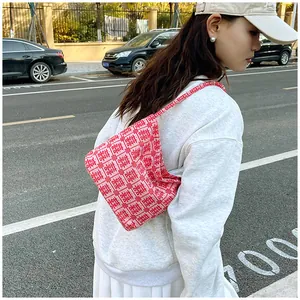 Outdoor lifestyle shot of a Chinese wedding tote bag featuring red and pink Xi patterns