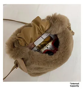 Detail view of the interior capacity of the brown plush bag with cosmetics and sunglasses