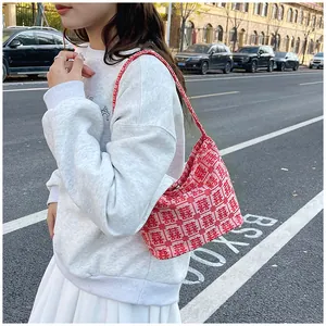 Close-up of red and white knitted jacquard tote bag with traditional Double Happiness pattern