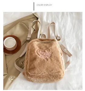 Detail of khaki plush backpack featuring heart embroidery and soft fleece texture