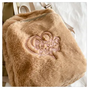 Dettaglio zaino in peluche marrone con morbida ecopelliccia e ricamo a cuore rosa
