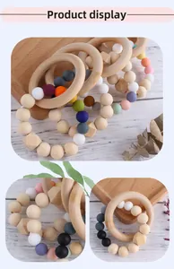 Detail eines Beißrings aus Holz mit Macaron-Silikonperlen zur Linderung beim Zahnen