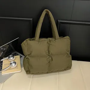 Quilted olive green puffer tote bag with spacious interior for daily commute