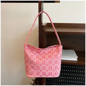 Close-up of pink bridal tote bag with red Xi characters and canvas texture details