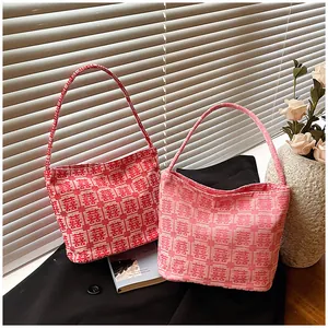 Detailed texture of red and pink bridal tote bags with Chinese Xi characters