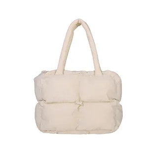 Minimalist cream white quilted tote bag with large puffer squares and shoulder straps