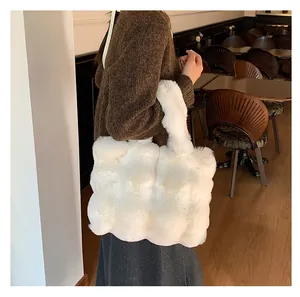 Detailed close-up of a large white plush tote bag with a soft quilted faux fur texture