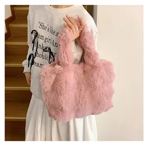 Detailed view of pink plush tote bag with thick handles held by a model on a staircase