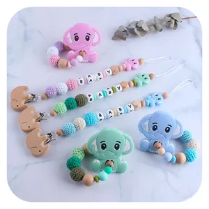 Silicone elephant baby teether and beech wood pacifier clip set in pink, green, and blue