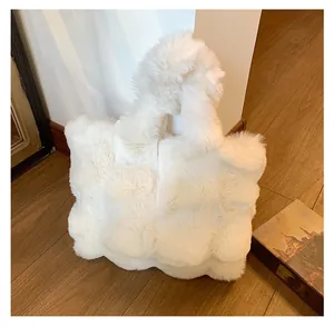 Detail view of the soft white plush tote bag texture with fluffy faux fur material