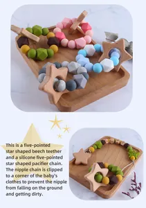 Detail of wooden star teether with colorful silicone beads and baby pacifier clip