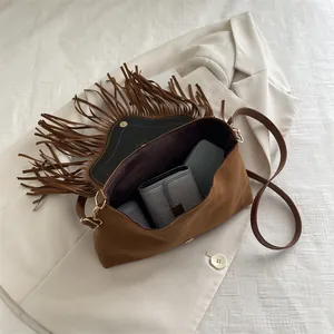 Vintage brown suede fringe crossbody bag with gold buckle and spacious interior