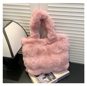 Close-up of fluffy pink faux fur tote bag placed on a magazine with soft lighting