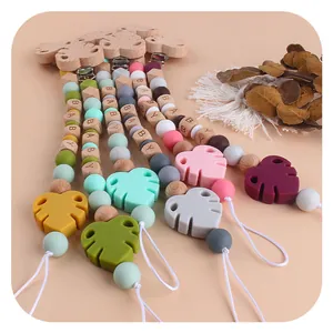 Silicone baby pacifier clips with beech wood beads and colorful monstera leaf pendants