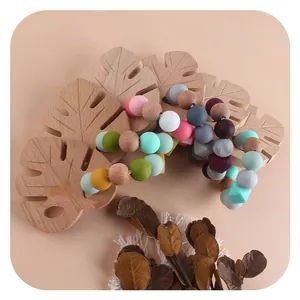 Handmade baby pacifier clip with colorful silicone beads and natural beech wood leaves