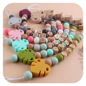 Handmade beech wood and silicone baby pacifier clip with monstera leaf and BABY letter beads