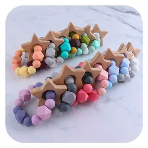 DIY baby teether bracelet with beech wood star and colorful silicone beads on marble