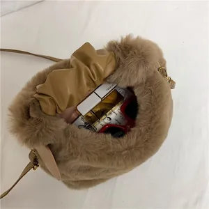 Brown faux fur bucket bag with leather drawstring showing interior storage space