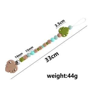 Beech wood and silicone baby pacifier clip with green leaves and letters beads