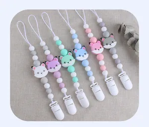 Detailed view of colorful silicone beads and cartoon fox charms on baby pacifier clips