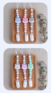 Detailed view of silicone pacifier clips with cute fox beads in various pastel colors