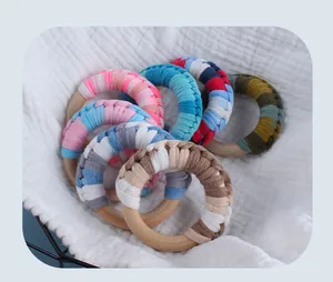 Macro shot of handcrafted colorful cotton woven textures on baby wooden teething rings