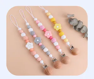 Set of 4 baby pacifier clips with silicone beads, crochet balls, and beech wood fasteners