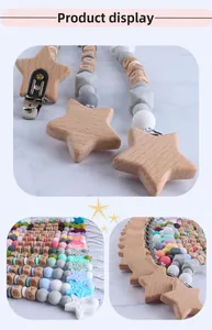 Detail of beech wood star pacifier clip with silicone beads and letter beads on marble