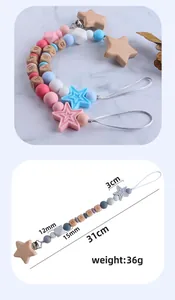 Detailed size view of a handmade baby pacifier clip with beech wood stars and silicone beads