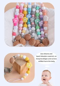 Detail of beech wood pacifier clip with silicone beads and rose teether for infants