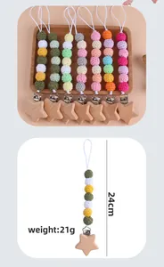Detail view of beechwood star pacifier clips with colorful crochet beads, 24cm long