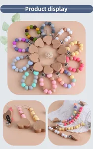 Detailed macro view of colorful silicone beads and beech wood heart pacifier clips