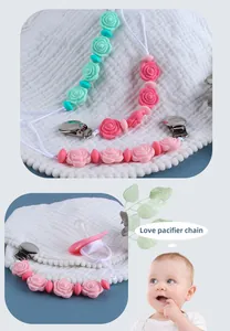 Detailed view of silicone rose pacifier chain in mint green and pink with metal clip